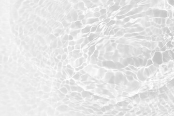 Blue water with ripples on the surface. Defocus blurred transparent blue colored clear calm water surface texture with splashes and bubbles. Water waves with shining pattern texture background.