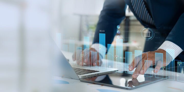 Finance and data analysis. Businessman doing investment and financial analytics utilizing technology and data strategies to optimize business growth and navigate economic trends
