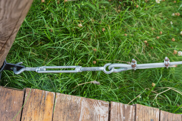 Steel cable is taut with turnbuckle for installed garden structure