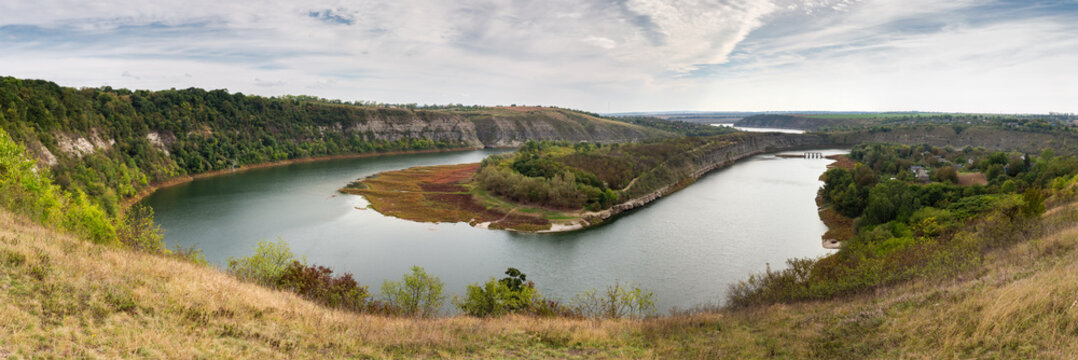 Bends Zbruch river in canyon-like valley with rock banks