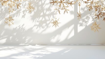 Elegant minimalist design with white backdrop and glittering gold snowflakes for the holidays