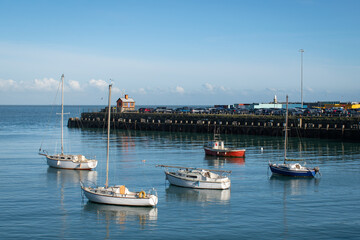 Fototapeta premium Boats in harbour blue sky peaceful blue turquoise sea 