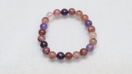 Natural gemstone bracelet display on white bqackground