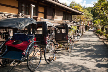 Row of Rickshaw parking next to traditional Japanese houses in Takayama, Japan