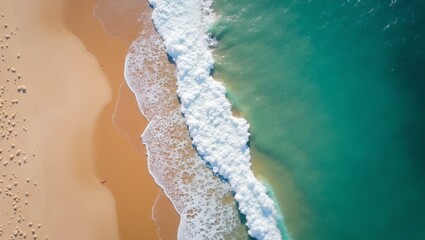 Crystal clear waters meet white sandy beach from above