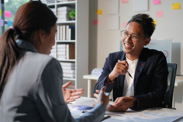 Asian business people having meeting discussing business ideas using laptop computer together in office workplace