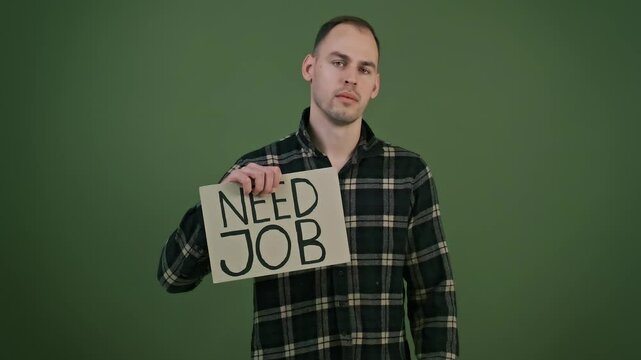 Frustrated unemployed young adult holding cartons marked NEED JOB and MONEY