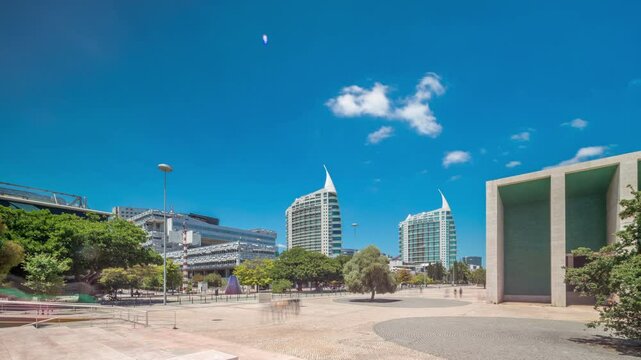 Parque das Nacoes (Park of Nations) in Lisbon timelapse hyperlapse. Modern Cultural Center And a Place For a Shopping Mall, expo Pavilions Buildings and Hotels. Walking alleys with green trees