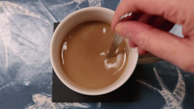 Stirring Tea Coffee Mug Spoon Hot Beverage Hand Fingers Close Up Top Down View