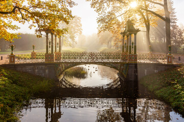 Chinese bridge on misty autumn morning in Alexander park, Pushkin (Tsarskoe Selo), Saint...