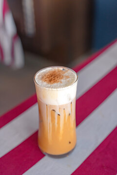 Iced Cappuccino in a Tall Glass on a Table - Refreshing Coffee Beverage for a Hot Day
