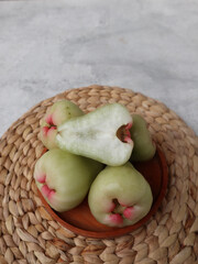 Deli green honey guava or jambu madu Deli Hijau which has a sweet and fresh taste. served on wooden plate. Water apple (water guava)