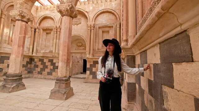 Woman Walking In Old Places,Photographer tourist visits Ishak Pasha Palace in Ağrı, admiring its stunning architecture. 