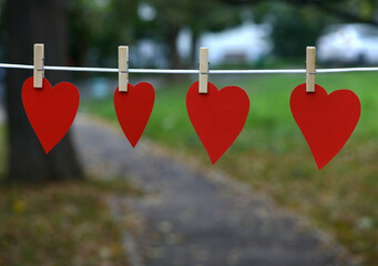 Heart shaped paper Pink color hanging on a rope with copy space for text Valentine's Day concept