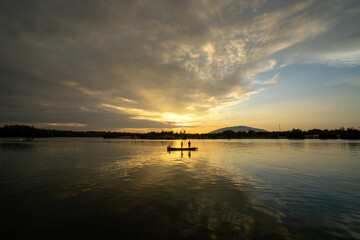 Fishermen are fishing in the river in the morning time.