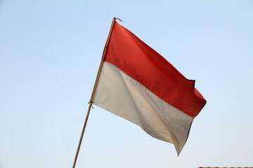 the red and white flag, the Indonesian flag installed on the fence being exposed to the wind
