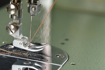 Professional sewing machine on blurred background, macro view