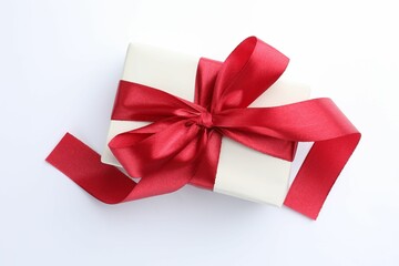 Beautiful gift box with red bow isolated on white, top view
