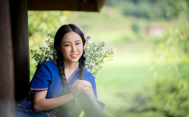 Yindicating a rural or countryside setting, with a peaceful and scenic environment that suggests a close coung girls standing on a wooden porch, looking outward with expressions of joy and curiosity. 