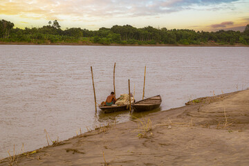 Gorai-Madhumati River. Fishing boat in the river. Fisherman is fixing the fishing net on the boat....