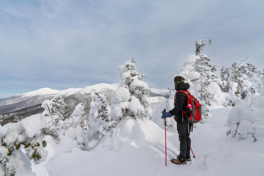 hiker at the top of Mt Pierce in snowy conditions