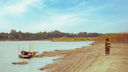 Fototapeta premium Rivers of Asia Fisherman's Hilsa fishing boat. Rural scenery along the river banks of Bangladesh.