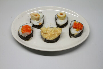 sushi rolls with rice and fish, soy sauce 
