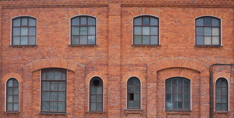 Modern windows in the old red brick wall