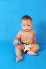 Adorable one year old Asian baby boy, playing lato lato style