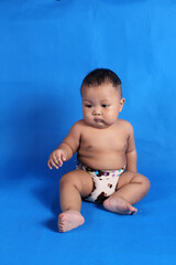 Adorable one year old Asian baby boy, playing lato lato style