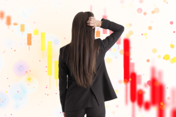 Woman with hand on head looking at falling stock market charts