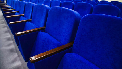 Blue empty seats in the audience prepared for the participants of the conference or presentation