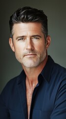 Obraz premium A handsome Caucasian man poses confidently, showcasing his features in natural lighting