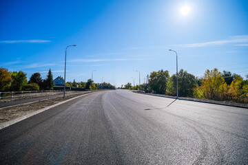 Construction of a new paved highway with sidewalks, lighting and road fencing