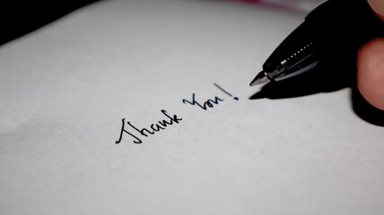 Writing of &ldquo;Thank You&rdquo; words  on paper