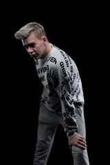 Young man posing in the dark in the studio