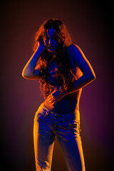 Young girl in red light, play of light and shadow