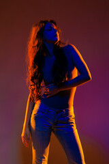 Young girl in red light, play of light and shadow