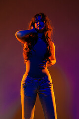 Young girl in red light, play of light and shadow