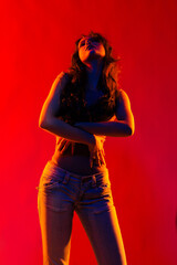 Young girl in red light, play of light and shadow