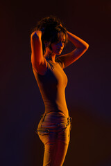 Young girl in red light, play of light and shadow