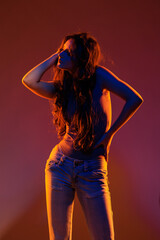 Young girl in red light, play of light and shadow