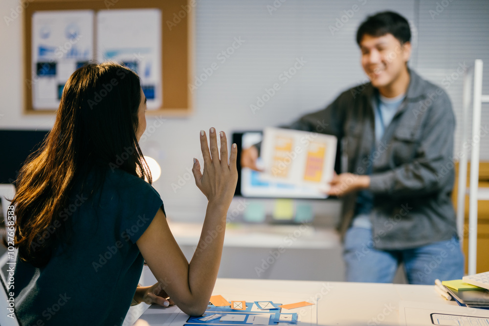 Poster two ui/ux designers discuss mobile app wireframes in a modern office, showcasing teamwork, creativit