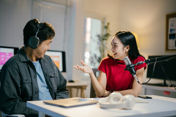 Two lively radio hosts recording a podcast in a bustling studio, immersed in creating entertaining content for their online audience