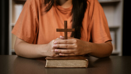 girl's hand sitting praying for god's blessing Along.  Power of hope or love and devotion.