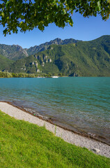 Scenic summer landscape of Idro alpine lake surrounded by high rocky wooded mountains, situated in Brescia, Lombardy, Italy, Europe