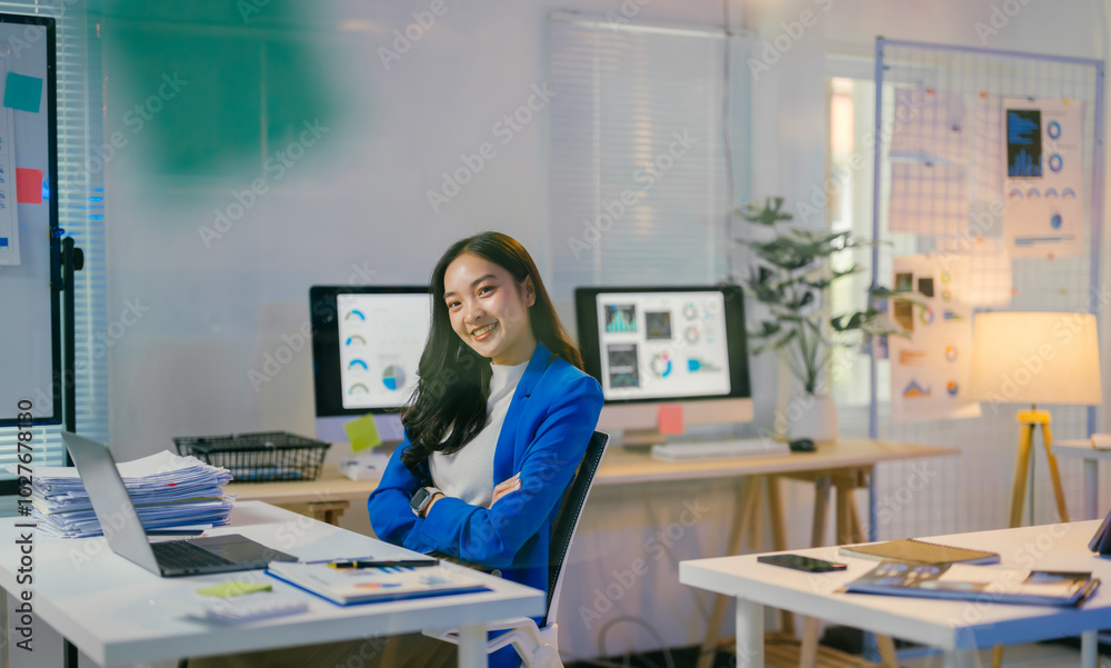 Aufkleber young professional is working late in her office, surrounded by computers and paperwork, with a dete