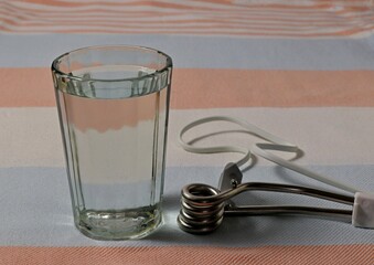 Image of a spiral heater and a glass of water.
