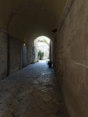 Fototapeta premium Narrow street in the old town center. Facade of old buildings. Puglia, Italy.