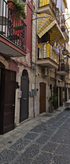 Narrow street in the old town center. Architecture of historic tenement houses in the Italian city. Bari, Puglia, Italy.